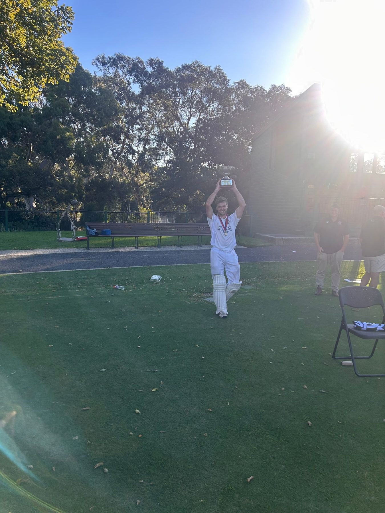 Trophy raised into the evening sun