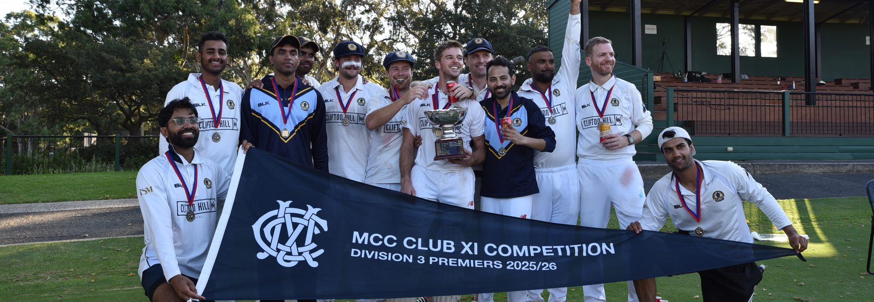 The 1st XI celebrating with the Division 3 premiership pennant and trophy, March 2026